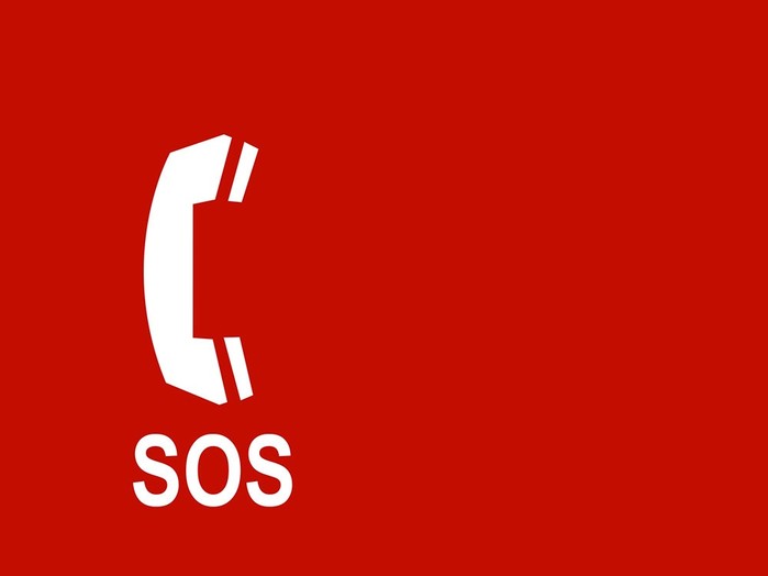 SOS-Notruf: Weißes Telefon auf rotem Hintergrund